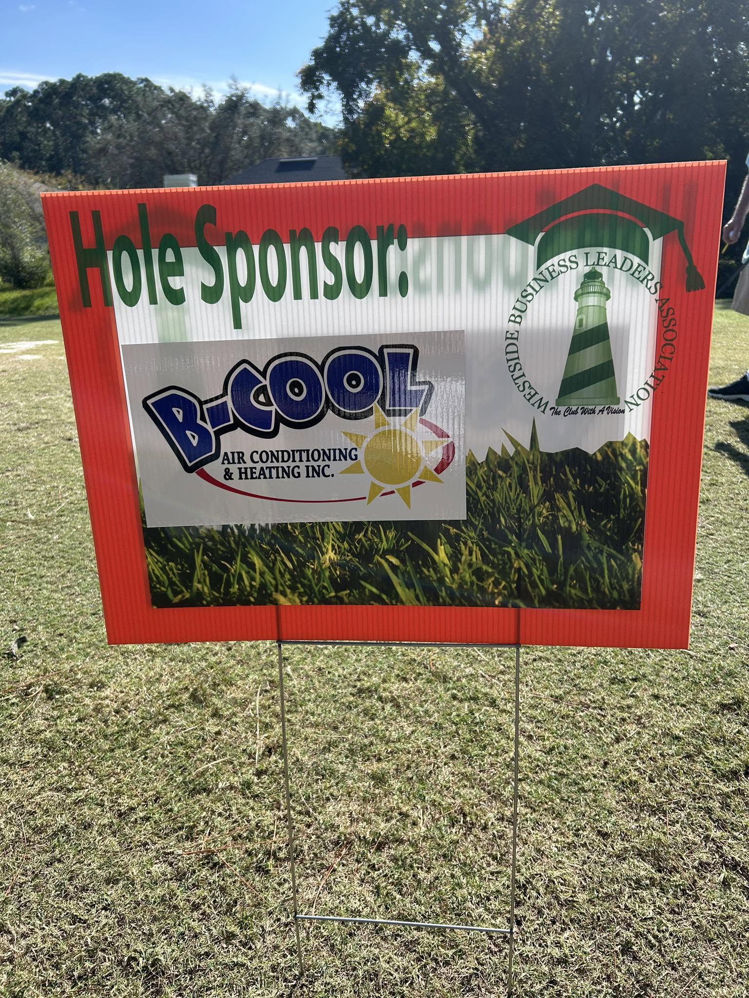 A Westside Business Leaders Association hole sponsor sign carrying the B-Cool Air Conditioning & Heating logo