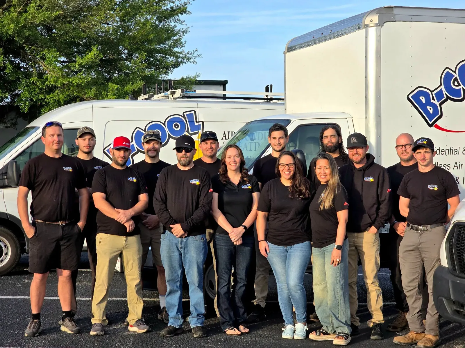 The B-Cool Air Conditioning & Heating team outside the shop with their service vans